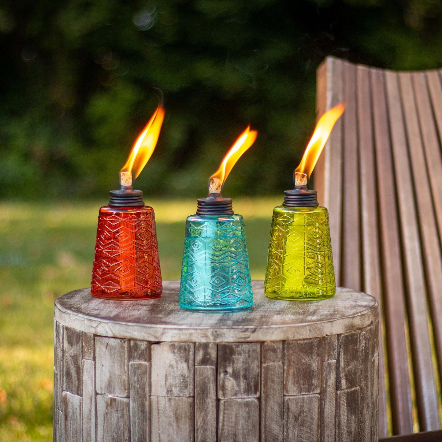 Enhance Outdoor Ambiance with TIKI Brand 1116040 Molded Glass Table Torches in Red, Green, and Blue - Perfect for Patios and Gardens